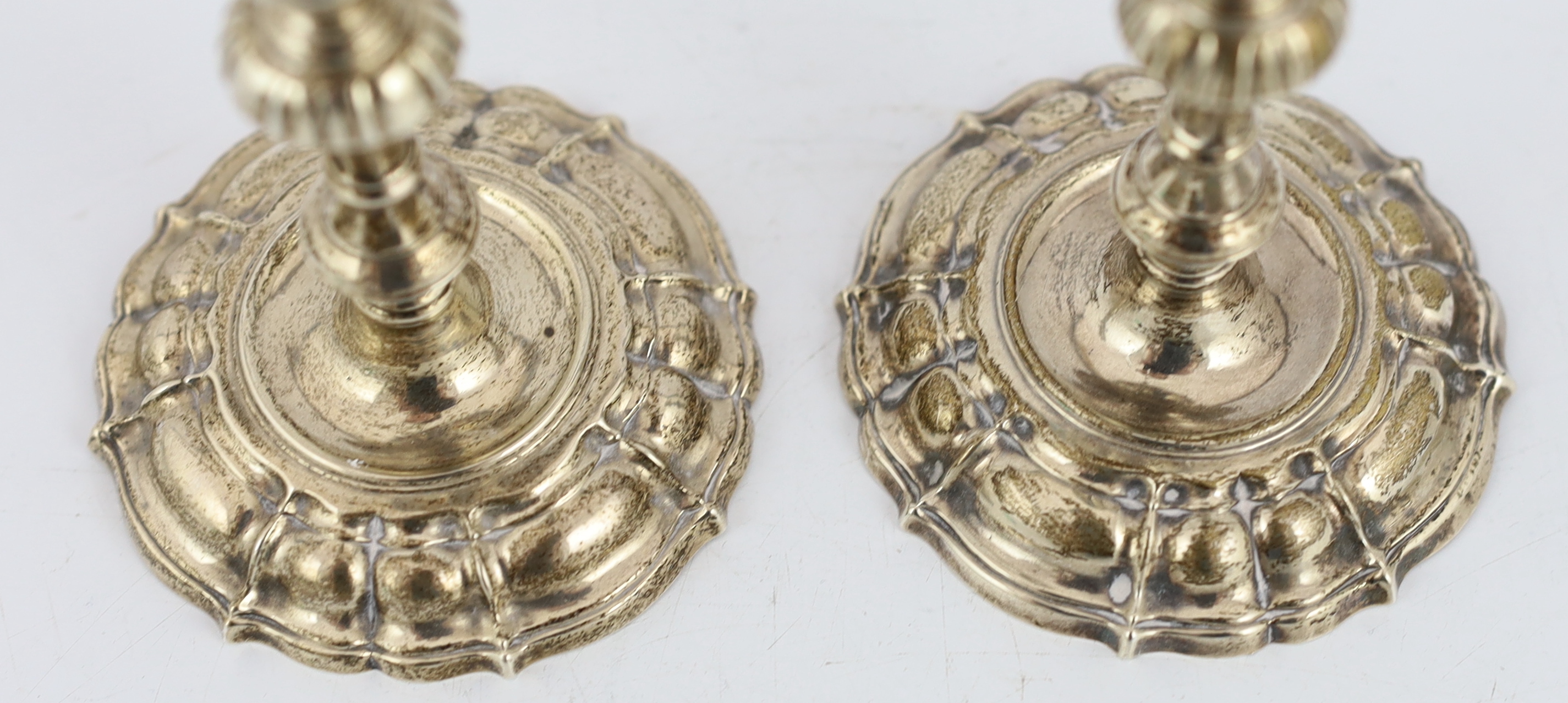 A pair of George II cast silver tapersticks, by James Gould